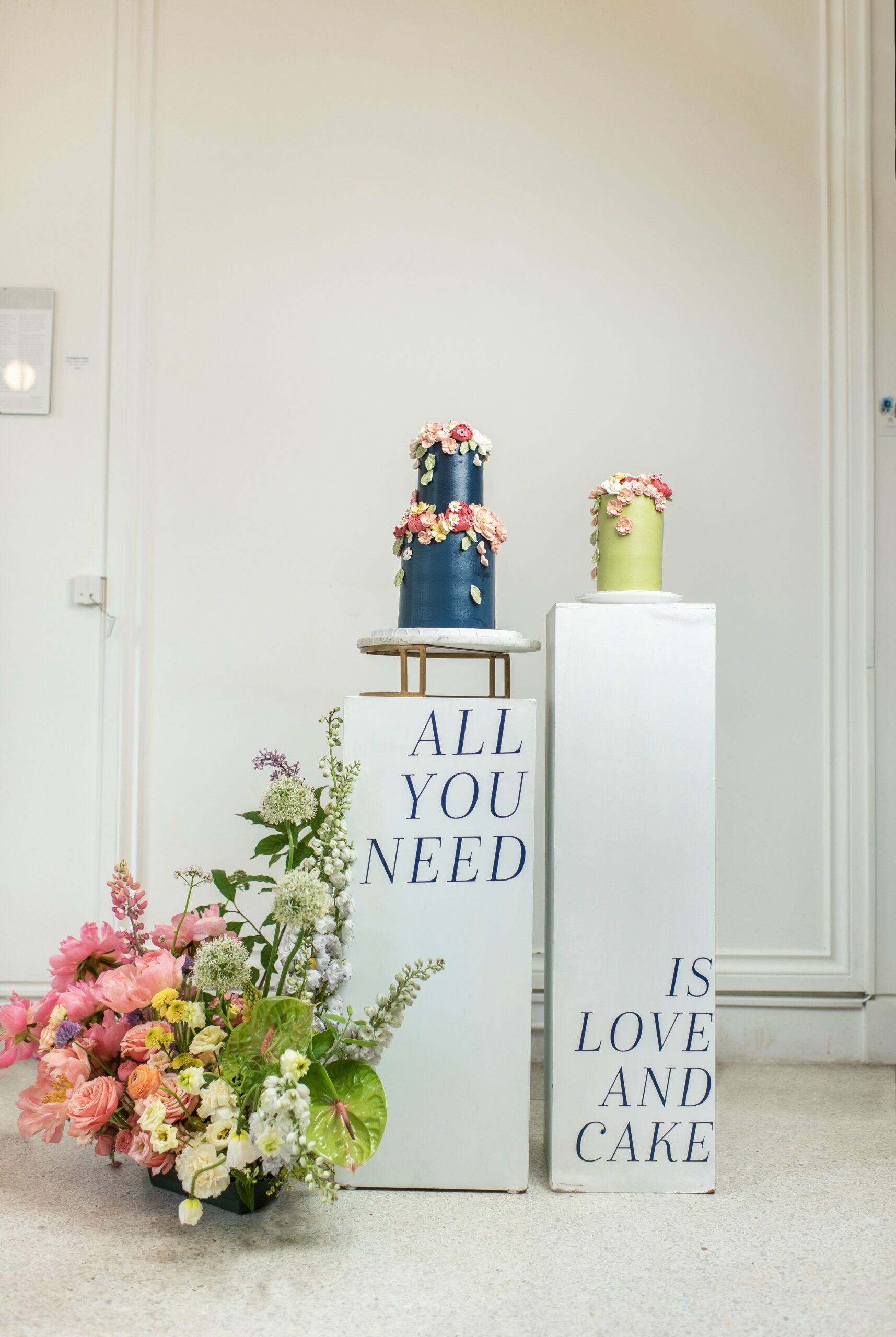 Modern wedding cake display with colourful flowers