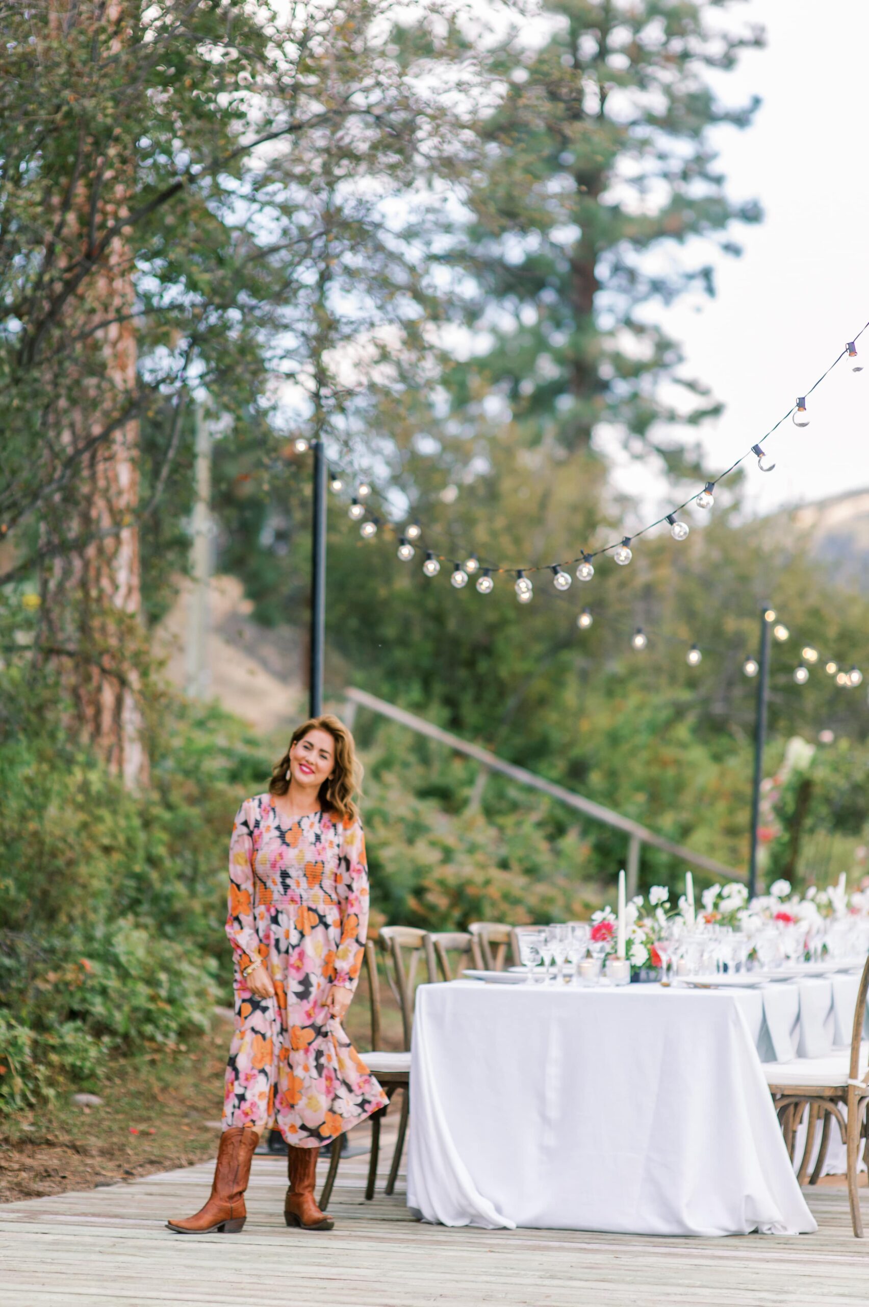 Jillian Harris standing next to long table dinner