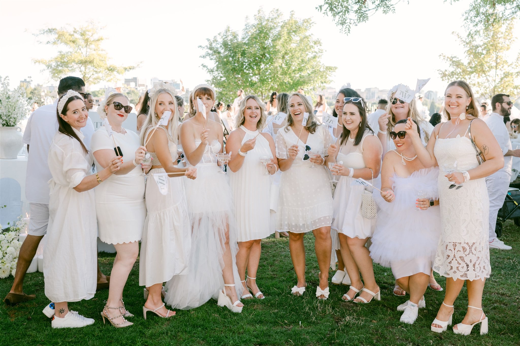 Ladies in white dressed holding white flags