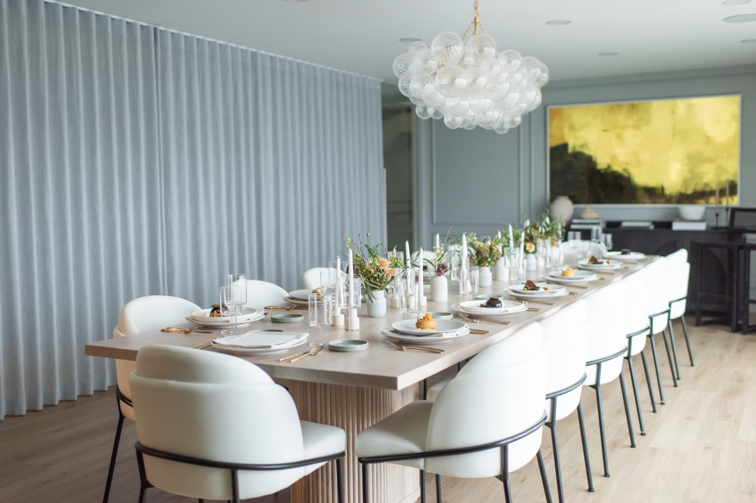 Long wood table with modern white chairs