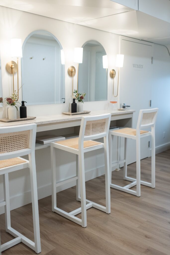 Bridal getting ready suite with white wood bar stools